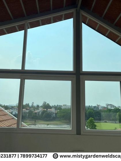 A stunning view from inside a terrace room at Prestige Augusta Golf Villa, framed by custom-fitted UPVC windows that offer panoramic views while providing insulation and noise reduction.