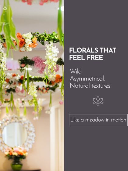 Florals that feel free and wild, like a meadow in motion, are a key trend. This suspended installation uses asymmetry and natural textures to create a sense of organic, effortless beauty.