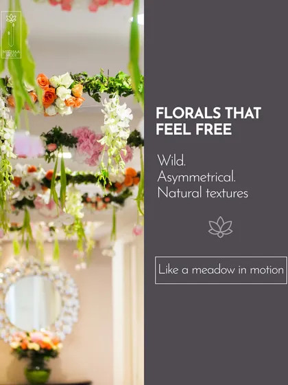 Florals that feel free and wild, like a meadow in motion, are a key trend. This suspended installation uses asymmetry and natural textures to create a sense of organic, effortless beauty.