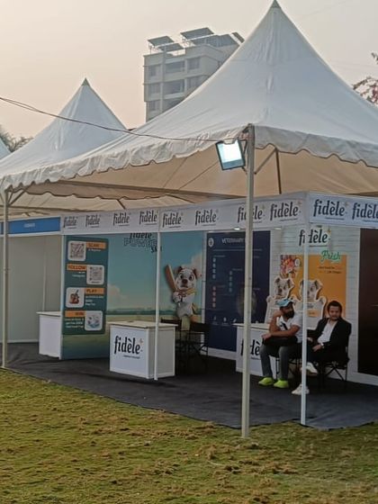 Vendor stalls I set up for Pet Fed Pune. I provide clean, uniform pagoda tents with backdrops and flooring, giving brands like 'Fidele' a professional space to showcase their products.