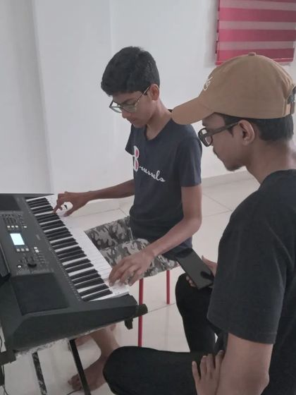 A student getting focused instruction on the keyboard. These moments of dedicated practice lead to great performances.