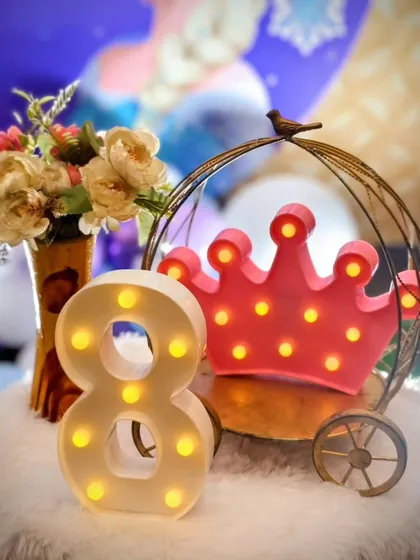 The small details make the biggest difference. I provide a variety of high-quality props like these illuminated marquee numbers and themed decor pieces to perfectly complement your party's style and add that extra sparkle.