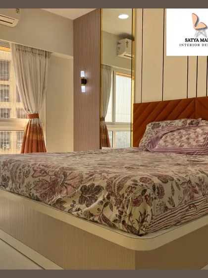 This close-up highlights the details of the bedside area, including the wall sconce and the seamless integration of the wardrobe.