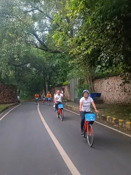 Cycling down a peaceful, tree-lined road during our Nizamuddin tour. This area offers a welcome escape into nature and history, away from the city's main hustle.