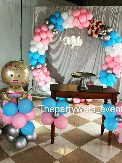 A classic baby shower theme with pink and blue balloons, "BABY" blocks, and cute baby foil balloons. This setup is great for a gender reveal party.