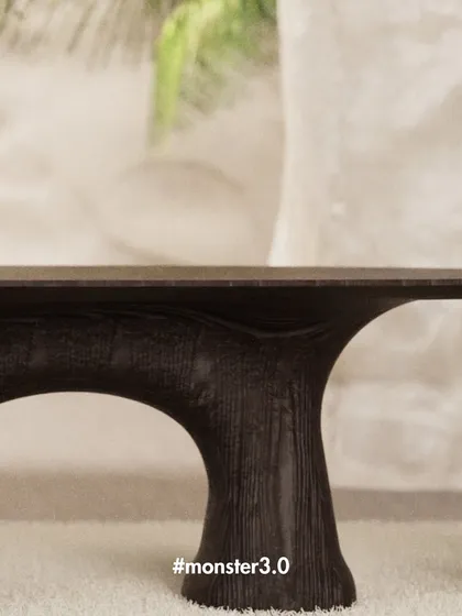 A preview of the Monster 3.0 collection, showcasing a table with a dark, textured finish and organic, root-like legs. This collection is all about exploring edgy forms and celebrating bold expression.