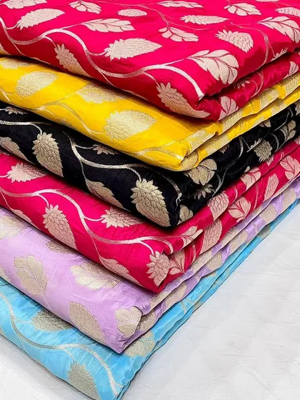 To show the beautiful range I carry, here is a stack of my designer crepe jacquard fabrics. The woven leaf pattern has a subtle sheen, available in a palette from bold fuchsia to classic black.