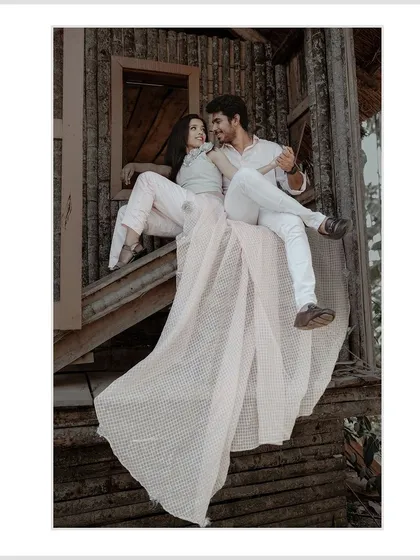 For pre-wedding shoots, I love getting creative with locations and poses. This shot in a rustic setting shows how we can create dramatic and memorable images that tell your unique love story.