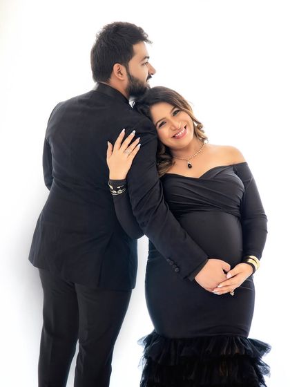 A joyful and loving pose. The way she leans on her partner shows the support and happiness they share as they look forward to meeting their baby boy.
