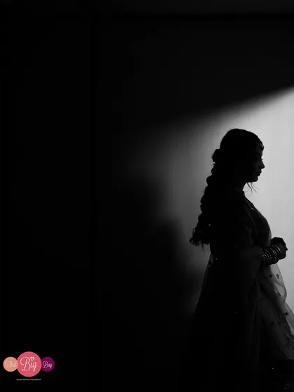 A dramatic silhouette of the bride, Ami, using light and shadow to create a powerful and artistic black and white portrait.