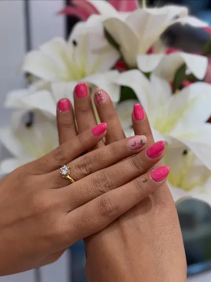 A simple and pretty design in a vibrant pink. The solid color is complemented by a single accent nail with delicate, abstract floral art.