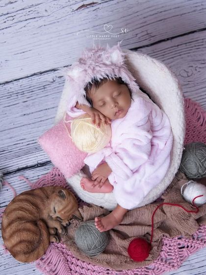 A little kitten in pink, playing with balls of yarn. This is a creative and playful take on the cat theme, perfect for a baby girl.