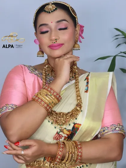 A close-up portrait focusing on the flawless makeup and the beautiful expression of the bride.