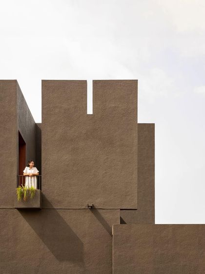 The 'H-House' by Studio Nirbaadh presents a monolithic, minimalist facade to the street, using mass and void to create a powerful architectural statement.