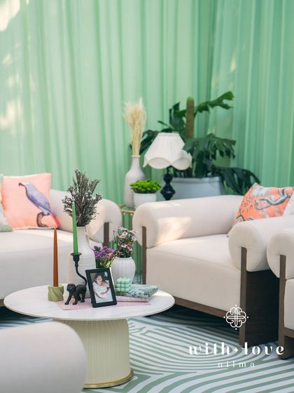 A cozy seating area in 'The Conservatory', with plush sofas and custom-printed cushions creating a comfortable and stylish space for guests.