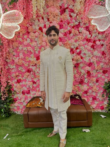 A full view of the textured off-white sherwani, showing its elegant length and tailored fit. This is a perfect outfit for a wedding guest or for pre-wedding festivities.
