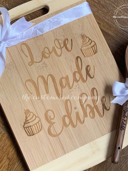 Elevate your culinary game with our signature cook set. This gift includes a wooden chopping board and spoon, both of which can be engraved with a custom phrase like "Love Made Edible" or a brand logo.
