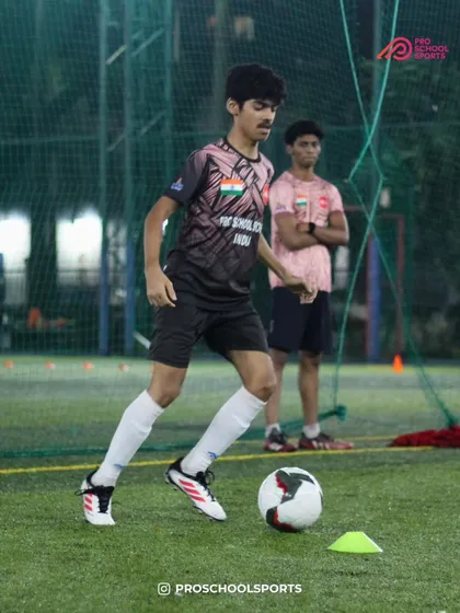 A player practices dribbling with precision around cones, honing their close control skills.