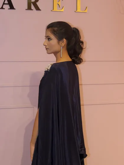 A side view of the navy blue kaftan, showing the elegant slit-sleeve detail and the flow of the fabric.