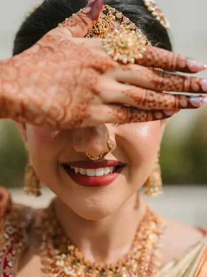 That moment of pure joy. This close up shows the flawless, dewy skin finish and the perfect bold red lip that completes a classic bridal look. It's all about creating a radiant glow that looks just as stunning in photos as it does in person.