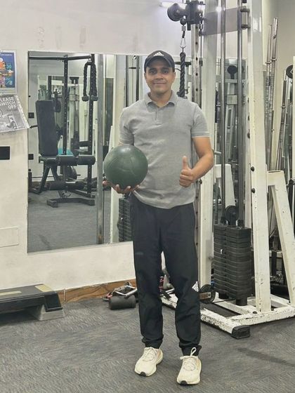 A confident thumbs-up in the gym. Ready to help you start your fitness journey.