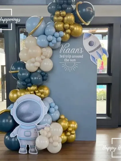 The finished photo booth setup for Viaan's space-themed party. This backdrop with a custom message and an astronaut cutout is the result of careful planning and execution, ready for guests to make memories.