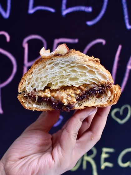 The cross-section of our Pear-Chocolate-Almond Twice-Baked Croissant. It's filled with a rich almond frangipane and chocolate, then baked again with poached pears for a deeply comforting treat.