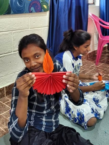 Another beautiful, handcrafted paper diya. The vibrant colors and careful folds reflect the festive spirit of Diwali.