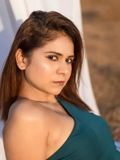 A stunning close-up from an outdoor shoot. The golden hour lighting and the model's intense gaze make for a captivating portrait.