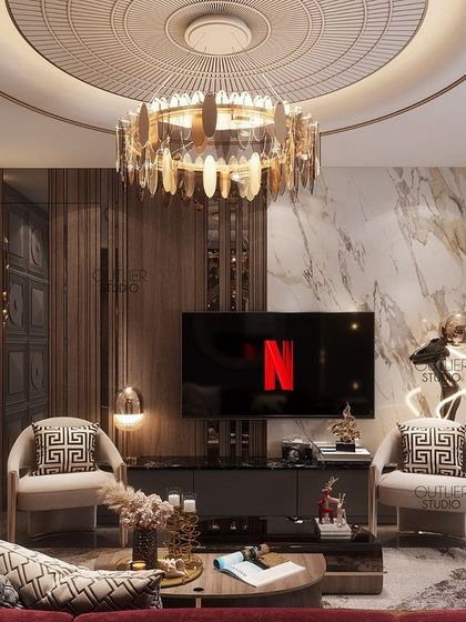 The perfect place for a late-night movie. This media lounge area features a unique 3D wall panel, a statement chandelier, and comfortable seating, blending modern design with a cozy atmosphere.