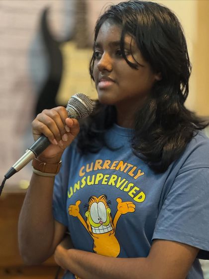 This student is learning to command the microphone and connect with her audience. Our classes build not just vocal skills but also stage presence.
