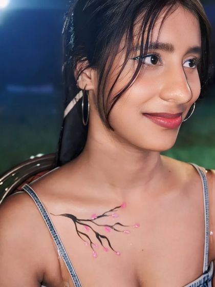 Another beautiful cherry blossom branch design, this time on the collarbone.