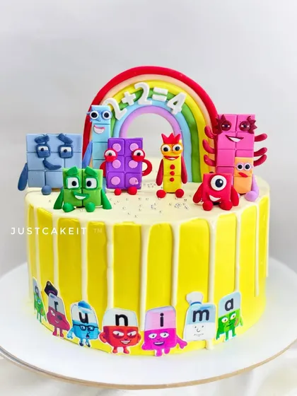 Learning is fun with this Numberblocks and Alphablocks theme cake. All the colorful characters are handmade and edible, sitting on top of a fresh pineapple cake with a white chocolate drip.