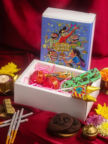 My Diwali hampers are treasures filled with love. This 'Pataka' box includes chocolate bombs, chocolate rockets, and cookies, making it a fun gift for all ages.