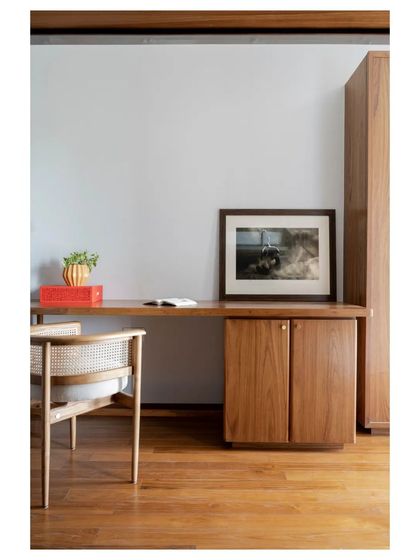 A simple, elegant study desk in teak, paired with a classic cane chair. A perfect example of my belief in clean lines and timeless materials for functional spaces.