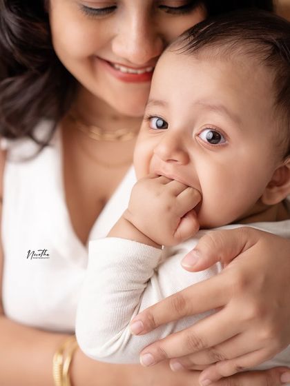 A close-up of a baby chewing on their fingers, a classic and adorable baby habit to remember.