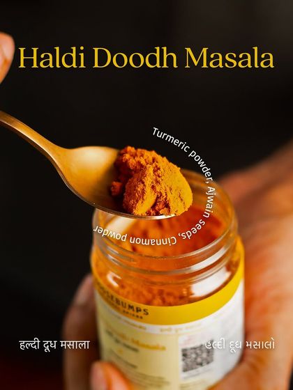 A spoonful of my vibrant Haldi Doodh Masala, showing its rich colour and texture. This blend is crafted to transform your daily milk into a comforting and healthy beverage.