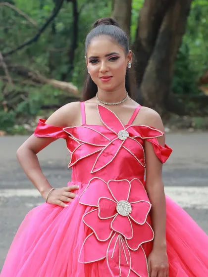 A close-up of the bright pink gown look, showing the clean and precise makeup application.