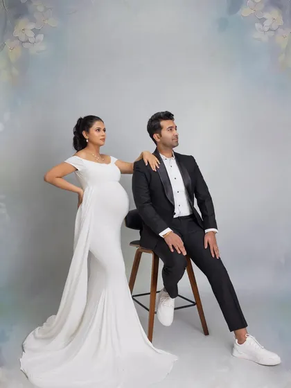 A stylish and classic pose for the expecting parents, showcasing their partnership and elegance.