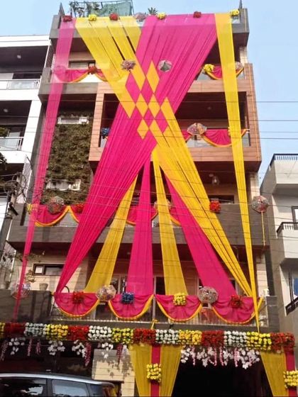 An impressive criss-cross draping design in yellow and pink that covers the entire front of a multi-story building, creating a bold statement.
