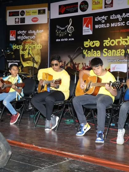 A group of our young guitarists performing an acoustic cover of 'Believer' at Kalaa Sangama 2023. This shows their ability to work together as an ensemble.