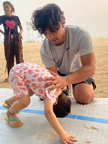 Here is one of our expert coaches providing gentle, one-on-one guidance during a bear crawl exercise. This hands-on support helps children master new movements, build core strength, and feel secure.