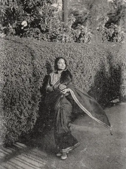 A full shot capturing the flow of the saree against a natural backdrop, edited with a vintage film effect to complete the 1950s aesthetic.
