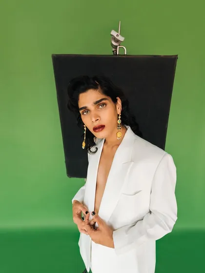 A candid-style shot from an Amama Jewels campaign, revealing the studio environment. This adds a layer of authenticity to the polished final look.