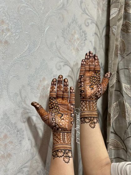 A minimal bridal design with a focus on symmetry. Both hands feature a beautiful tree-of-life motif inside a geometric frame, with delicate leafy patterns on the wrist.