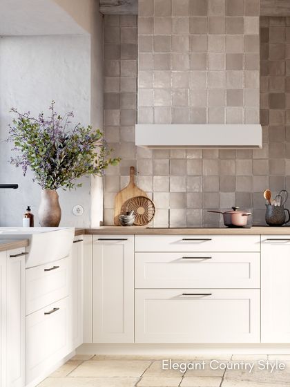 The concept130 RAVENNA White kitchen, featuring elegant country-style coffered fronts, a double basin sink, and a beautiful tiled backsplash.