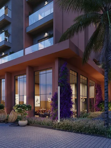 This exterior render showcases the entrance of a high-rise apartment building, where landscaping and lighting are used to create a welcoming and luxurious arrival experience. The design seamlessly integrates the building with its green surroundings.