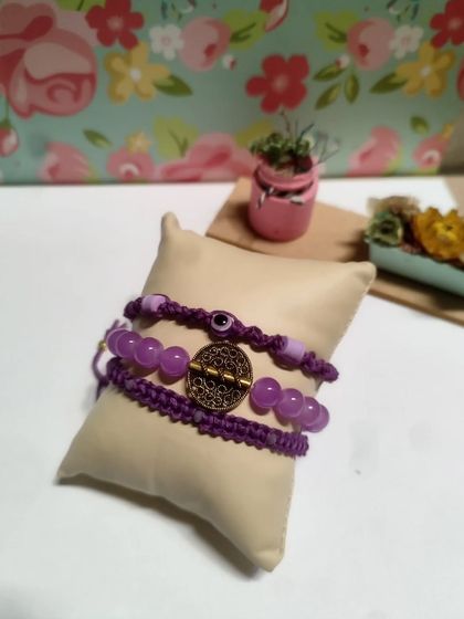 My collection of handmade bracelets, available in many colors and styles. I use beads, evil eye charms, and macrame techniques to create these stackable pieces.