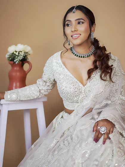 This all-white chikankari-style lehenga is the epitome of elegance. The full-sleeve blouse and intricate threadwork make it a sophisticated choice for a day event or reception.