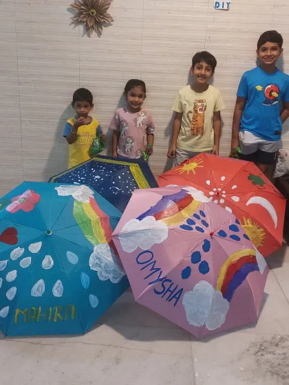 Look at these proud little artists with their hand-painted umbrellas. I provide the materials and guidance, and they bring the imagination. Every child gets to take home a unique creation they made themselves.